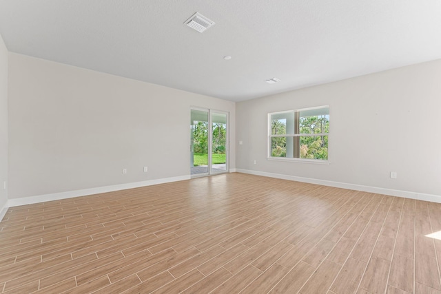 unfurnished room with light hardwood / wood-style flooring