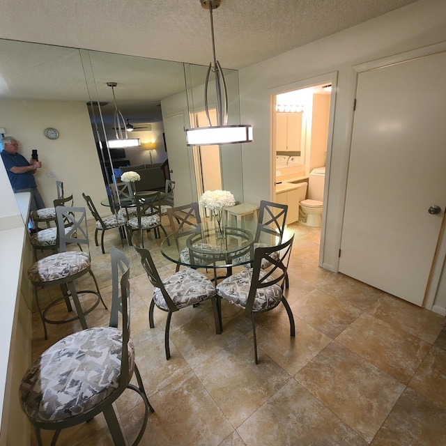 dining area featuring a textured ceiling