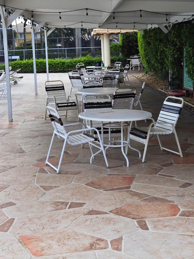 view of patio / terrace featuring glass enclosure