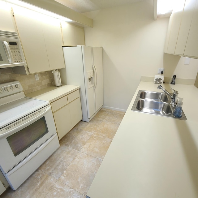 kitchen with backsplash, white appliances, sink, and cream cabinetry