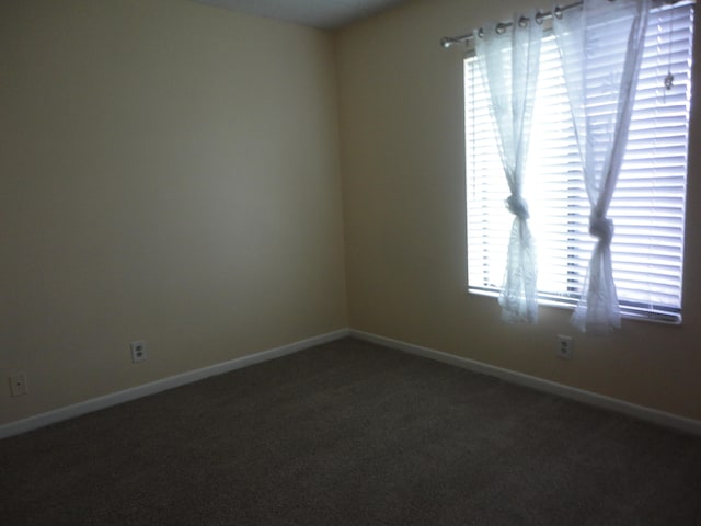 empty room featuring dark carpet