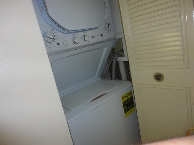 laundry room with stacked washing maching and dryer