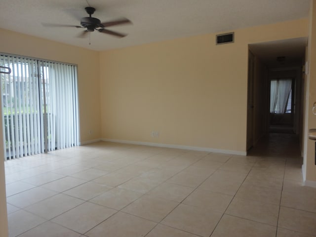 unfurnished room featuring ceiling fan and light tile patterned floors