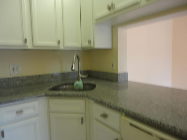 kitchen featuring white cabinets and sink