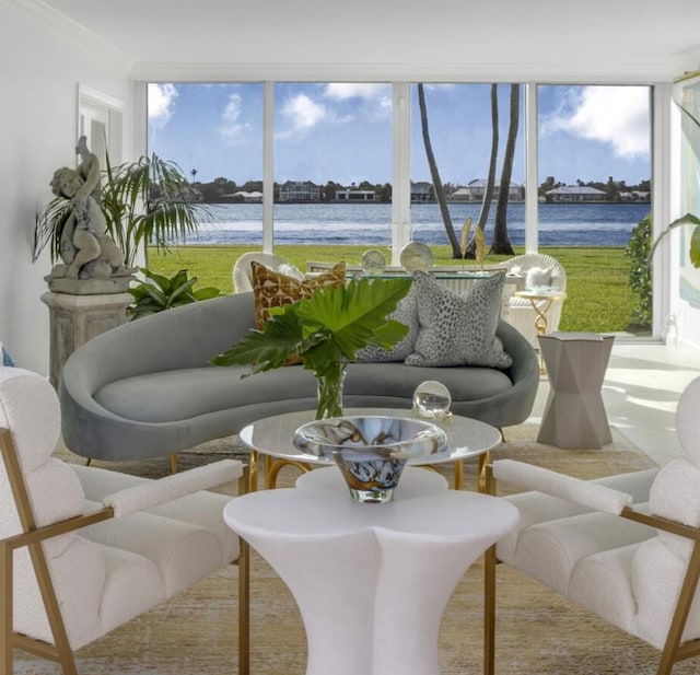 sunroom / solarium featuring a water view