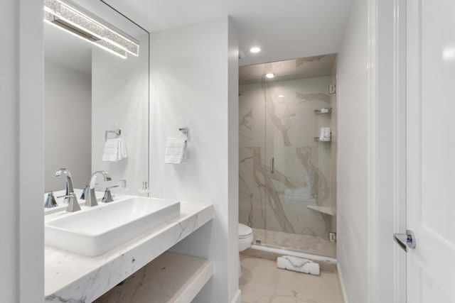 bathroom featuring sink, a shower with door, and toilet