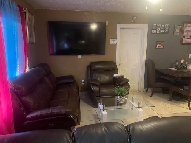 living room with light tile patterned floors and a textured ceiling