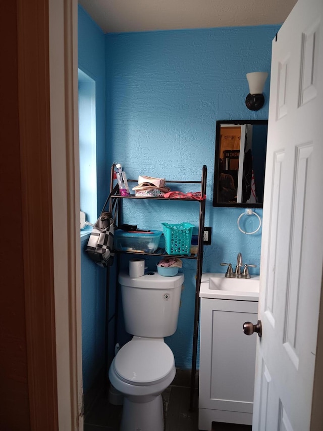 bathroom featuring tile patterned floors, vanity, and toilet