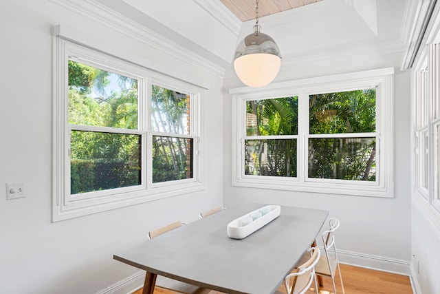 dining space featuring hardwood / wood-style floors and crown molding