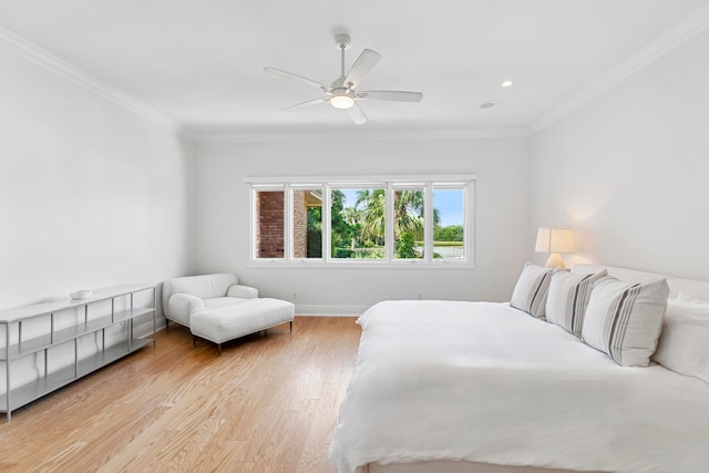 bedroom with ceiling fan, light wood-type flooring, and ornamental molding