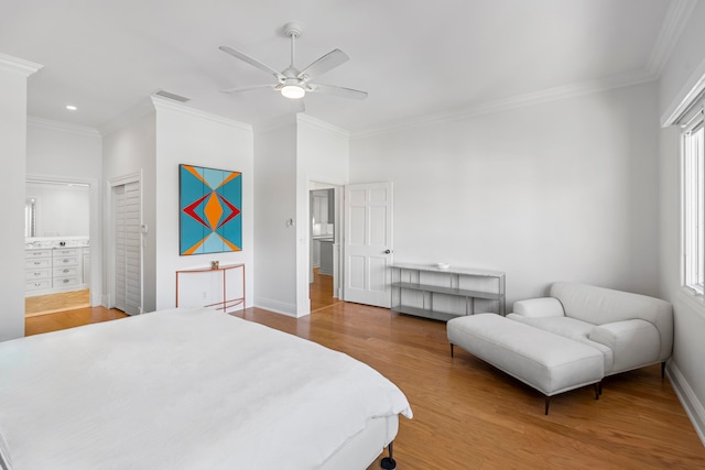 bedroom with hardwood / wood-style floors, ceiling fan, crown molding, and multiple windows