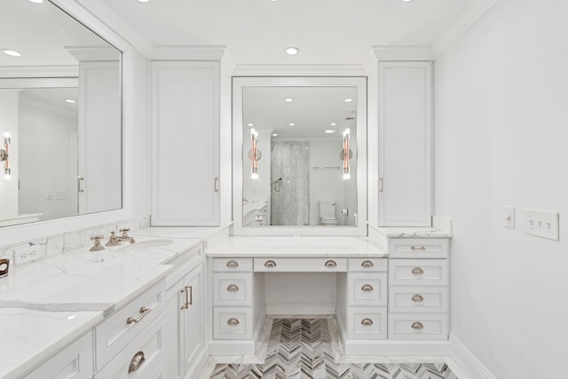 bathroom featuring toilet, vanity, crown molding, and a shower with shower door