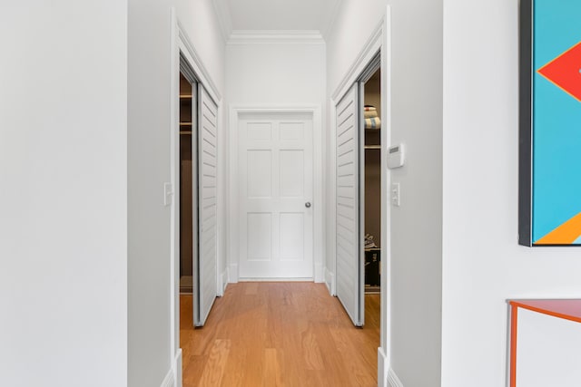 hallway with crown molding and hardwood / wood-style floors