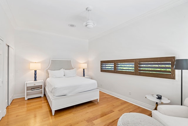 bedroom featuring a closet, ceiling fan, light hardwood / wood-style flooring, and ornamental molding