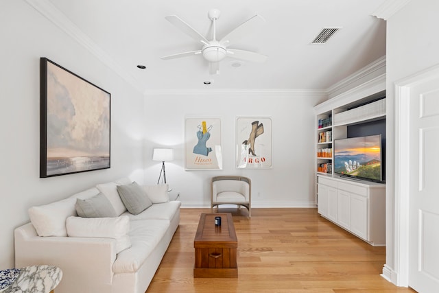 living room with ceiling fan, light wood-type flooring, and ornamental molding