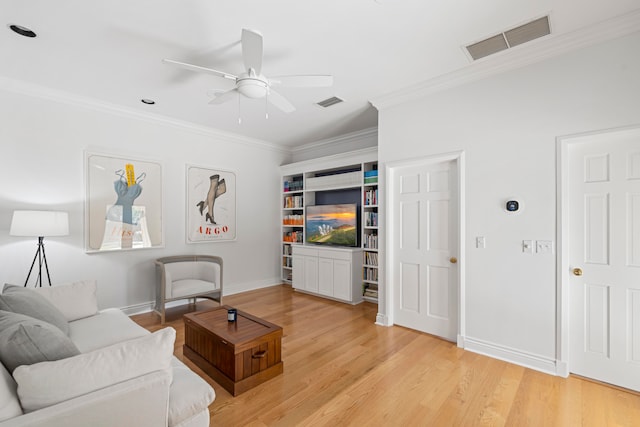 living room featuring crown molding, light hardwood / wood-style flooring, and ceiling fan