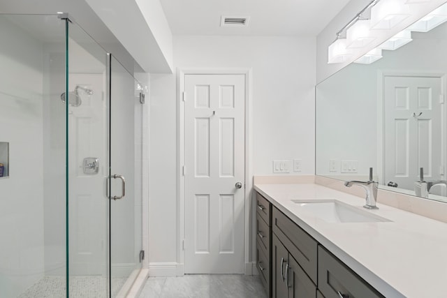 bathroom with vanity and an enclosed shower