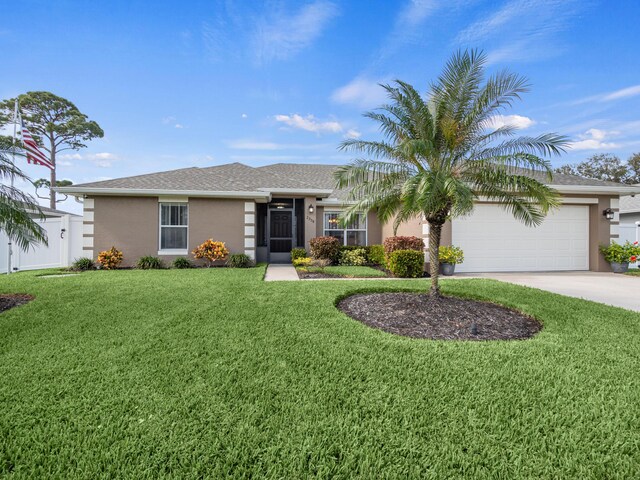 view of front of property featuring a lawn and a garage