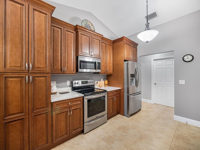 kitchen featuring pendant lighting, light tile patterned floors, lofted ceiling, and appliances with stainless steel finishes