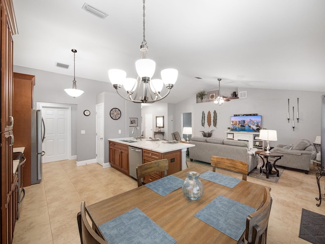 dining area with sink, vaulted ceiling, an inviting chandelier, and light tile patterned floors