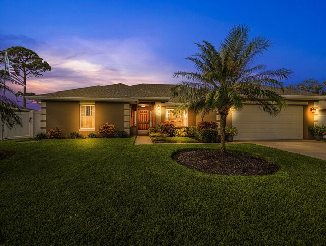 ranch-style house with a front yard and a garage