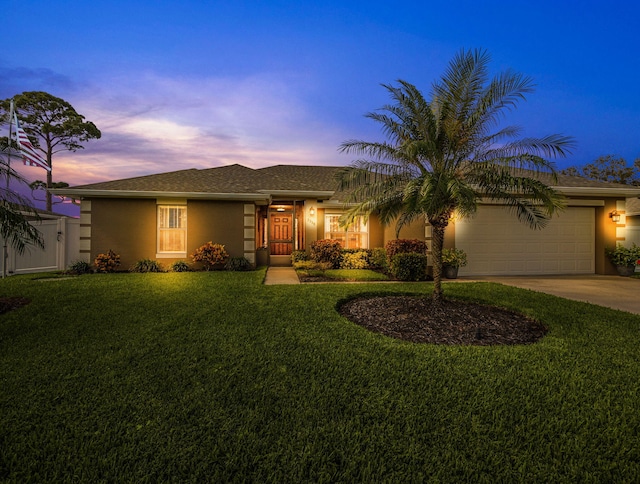 view of front facade with a lawn and a garage