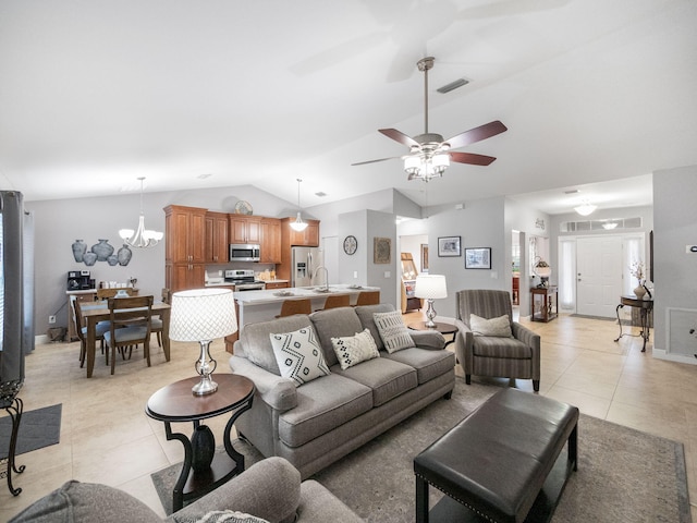 living room with sink, ceiling fan with notable chandelier, light tile patterned floors, and lofted ceiling