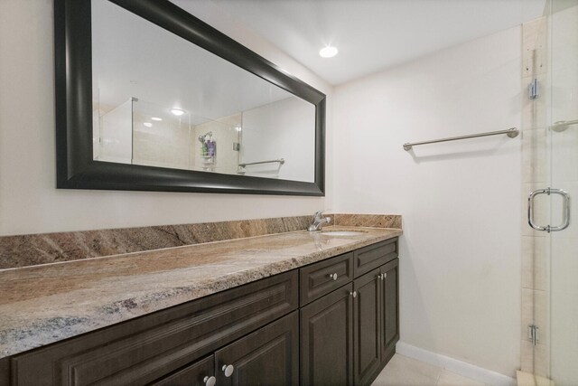 233 Charter Way, West Palm Beach, FL 33407 - full bath featuring a stall shower, double vanity, baseboards, and tile patterned flooring