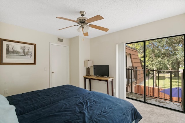 carpeted bedroom featuring ceiling fan, a textured ceiling, and access to outside