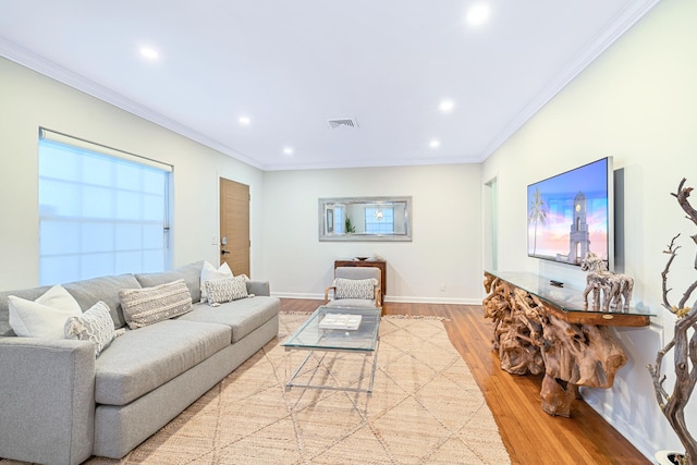 living room featuring light hardwood / wood-style flooring and crown molding