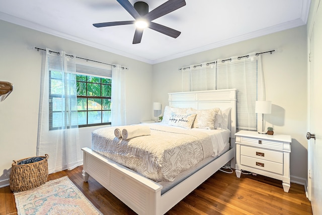 bedroom featuring ceiling fan, dark hardwood / wood-style floors, and crown molding