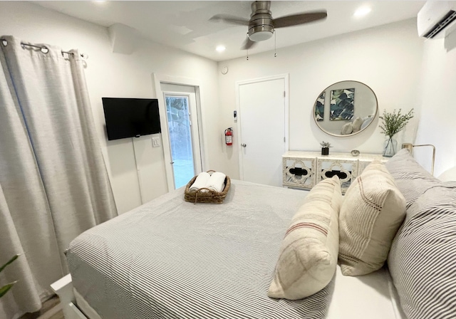 bedroom with ceiling fan and a wall mounted air conditioner