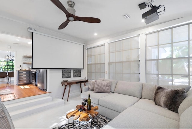 living room with hardwood / wood-style floors, ceiling fan, and crown molding