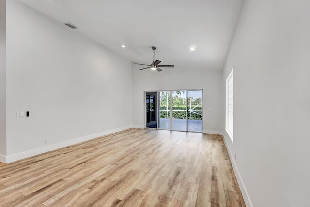 unfurnished room with ceiling fan, light wood-type flooring, and high vaulted ceiling