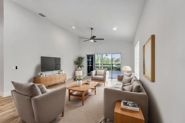 living room featuring high vaulted ceiling, light wood-type flooring, and ceiling fan