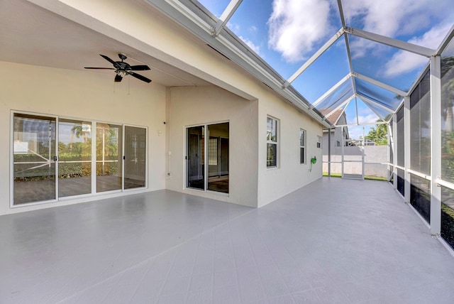 unfurnished sunroom with lofted ceiling and ceiling fan