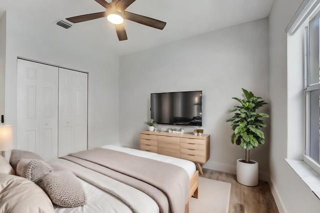 bedroom featuring a closet, hardwood / wood-style flooring, and ceiling fan