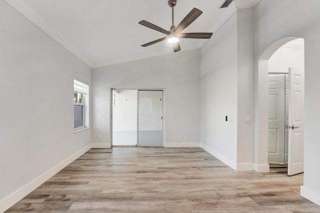 unfurnished bedroom with ceiling fan, light hardwood / wood-style flooring, vaulted ceiling, and ornamental molding