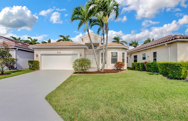 mediterranean / spanish home with a garage and a front lawn