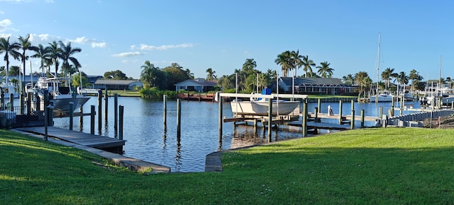 view of dock with a water view and a yard