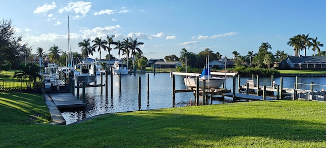 view of dock featuring a lawn and a water view