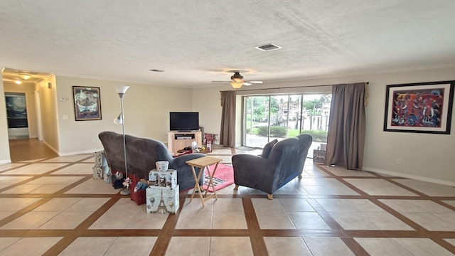 living room featuring a textured ceiling and ceiling fan