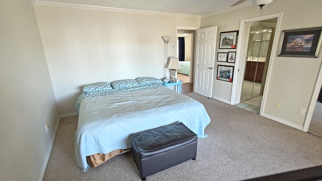 bedroom with ceiling fan, crown molding, light carpet, and connected bathroom