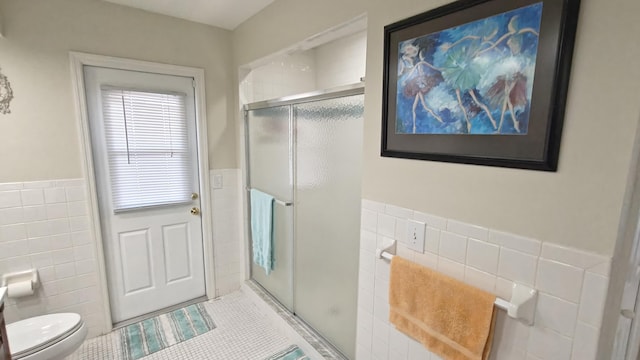 bathroom featuring tile patterned flooring, tile walls, and walk in shower