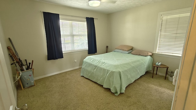 bedroom featuring a textured ceiling and light colored carpet