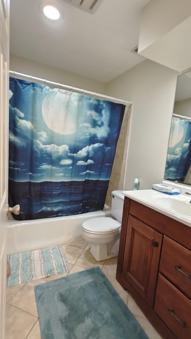 full bathroom featuring tile patterned floors, vanity, shower / bath combination with curtain, and toilet