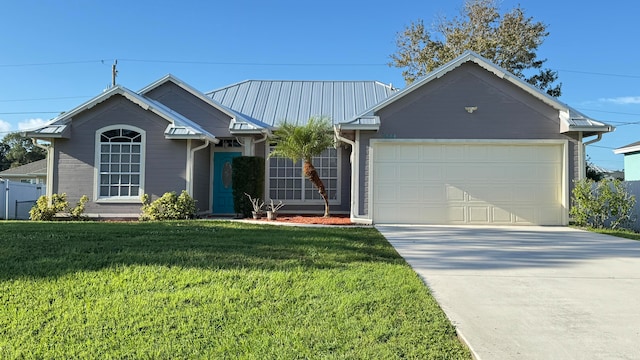 view of front of house featuring a front lawn and a garage