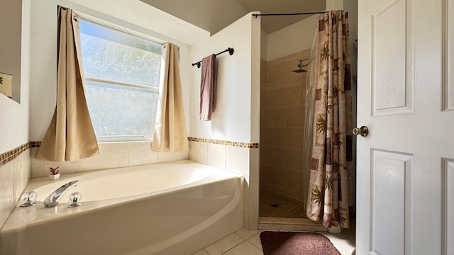 bathroom featuring tile patterned flooring and separate shower and tub