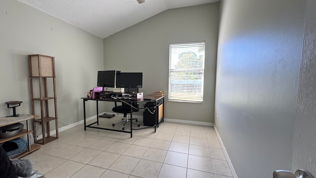 home office with light tile patterned floors and lofted ceiling