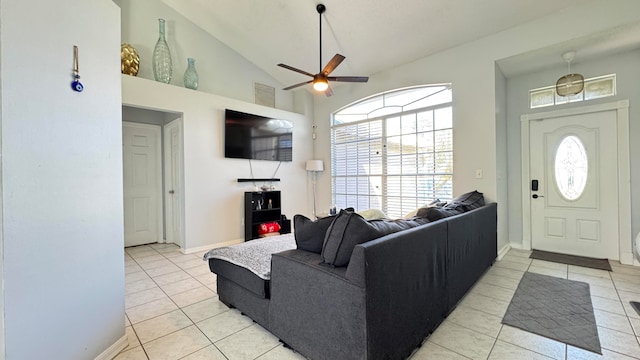 tiled living room with plenty of natural light, ceiling fan, and high vaulted ceiling